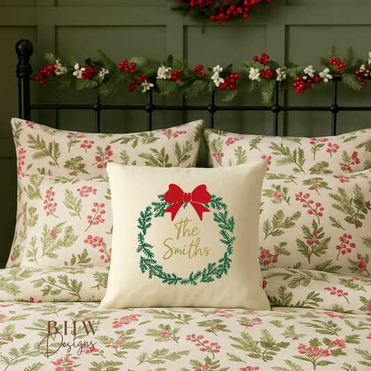 Christmas-themed bedding set with wreath design and 'The Smiths' text on a bed with decorative headboard and garland.