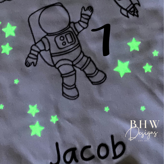 Children's top with astronaut design, number 7, and name 'Jacob' with glow in the dark stars