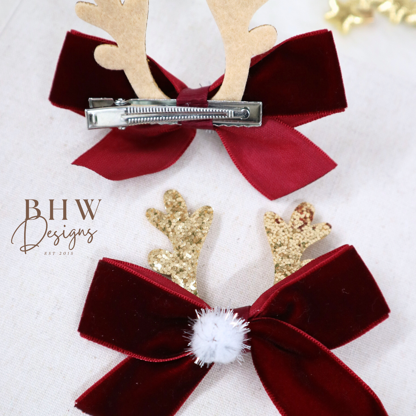 Two red velvet hair bows with gold antlers