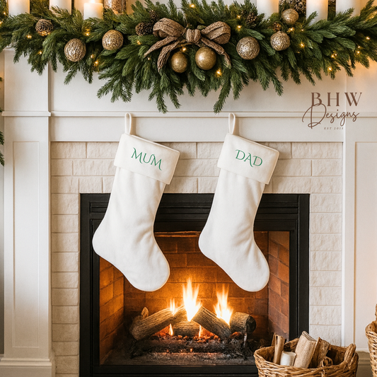 Christmas white velvet stockings hanging by a fireplace with mum and dad in green