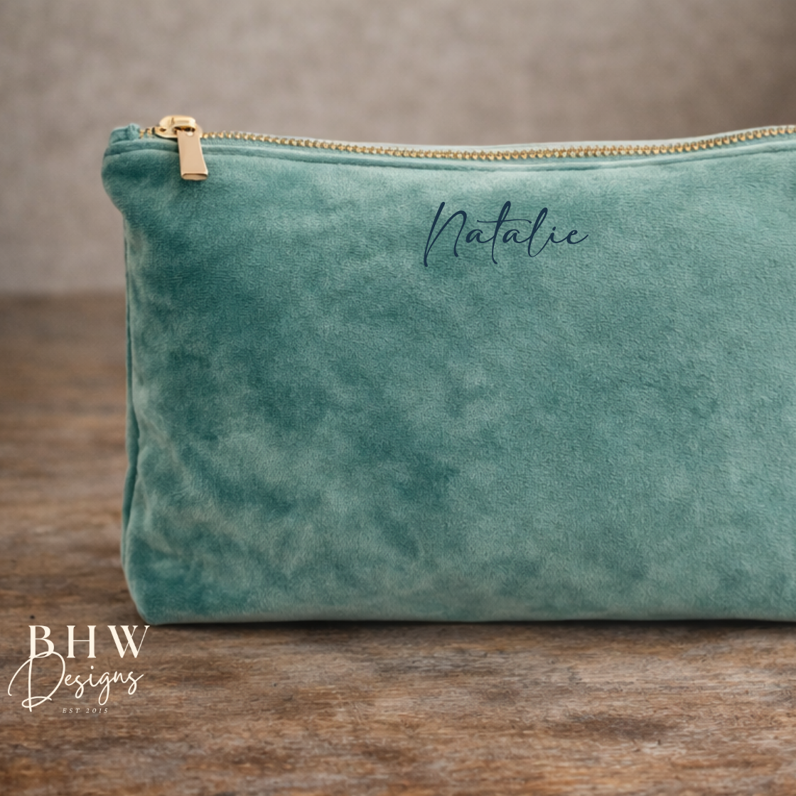 Green velvet pouch with gold zipper on a wooden surface, featuring the name 'Natalie' and 'BHW Designs' branding.
