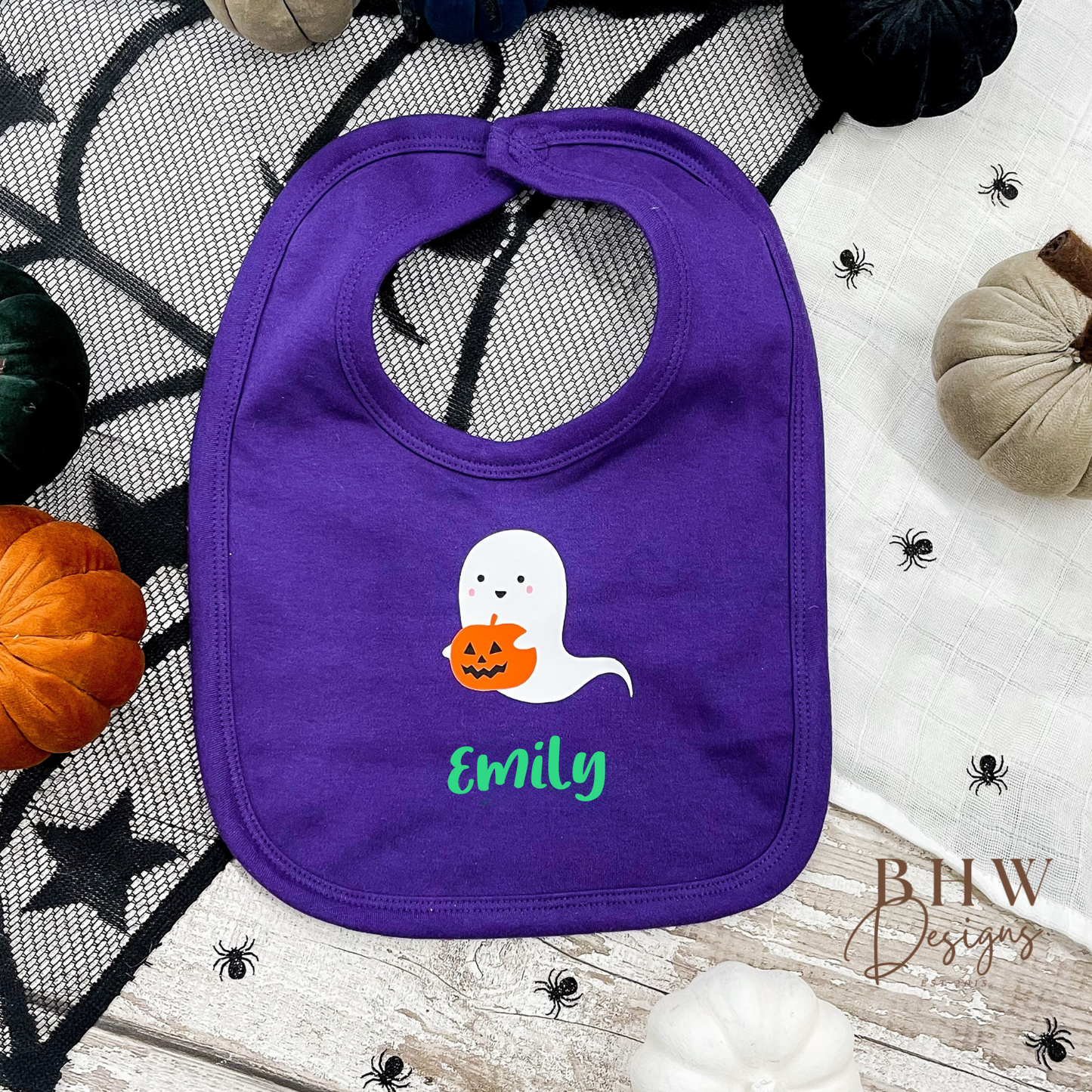personalised Purple bib with ghost design and 'Emily' text on a Halloween-themed background