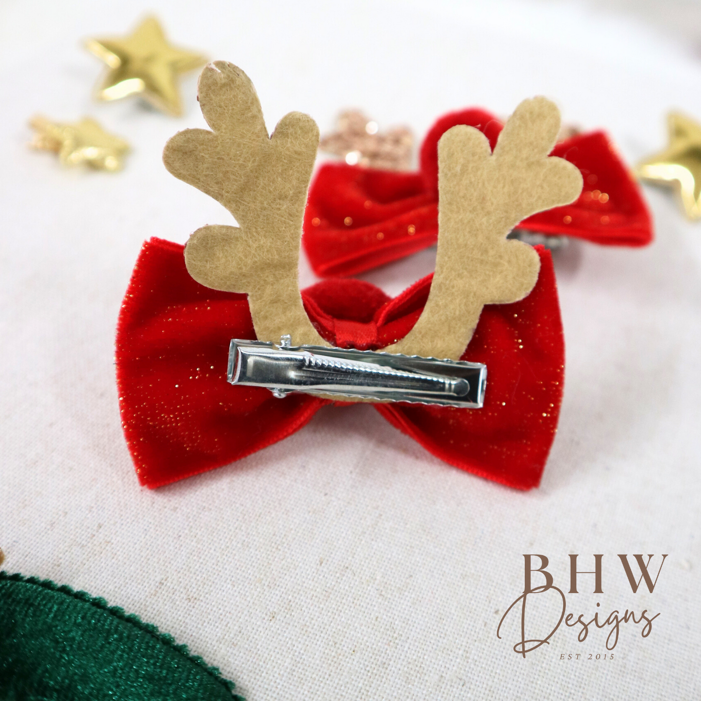 Red bow hair clip with gold antlers on