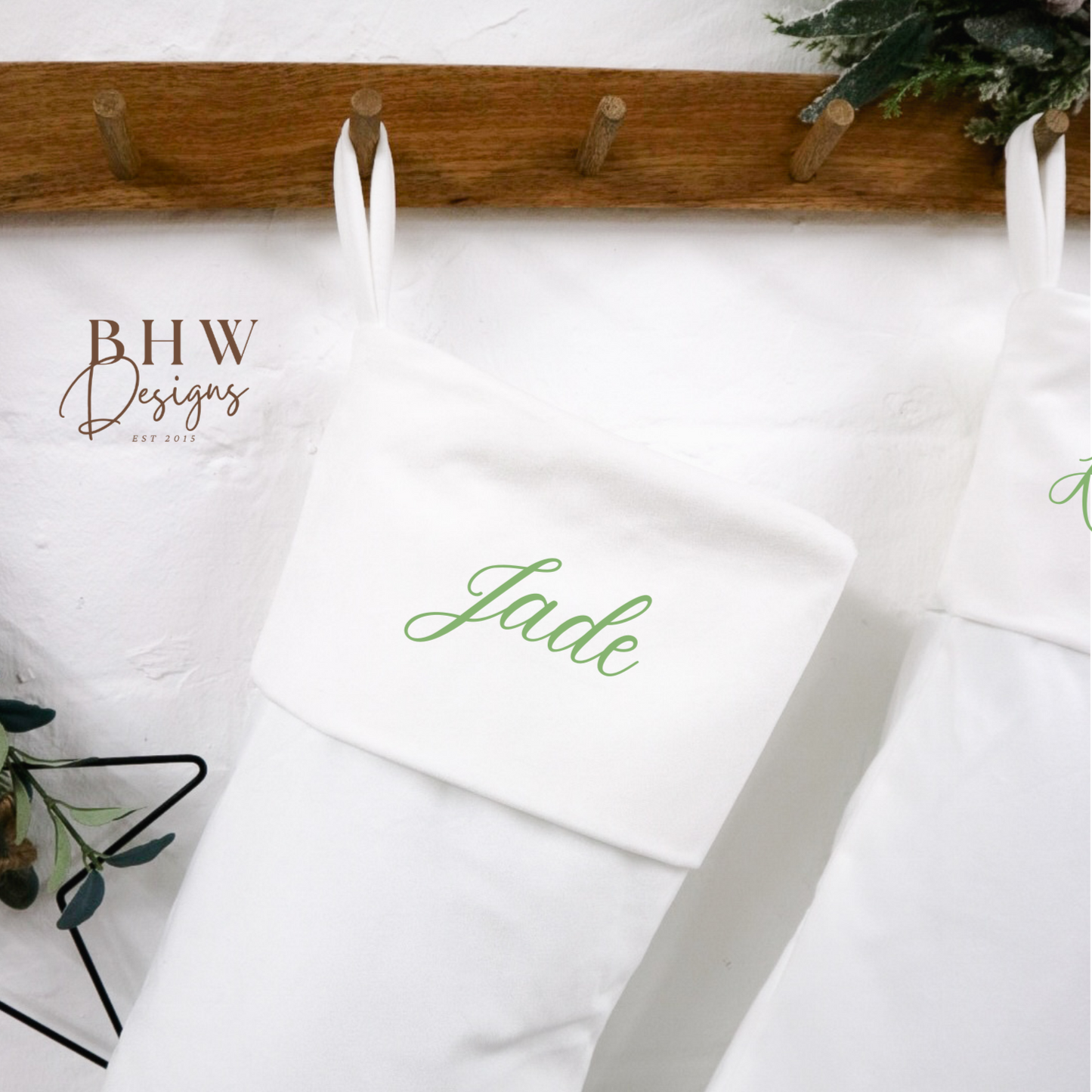 White stocking with 'Jade' personalised on it, hanging on a wooden rack
