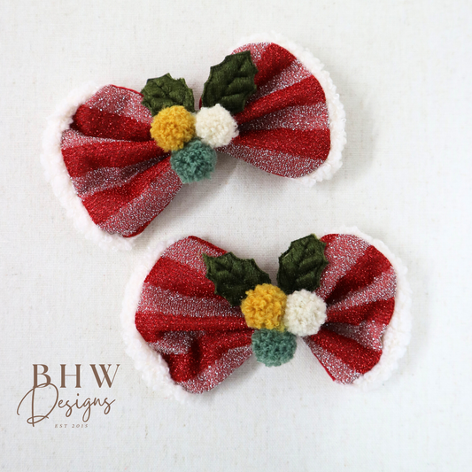 Two red and green decorative hair bows