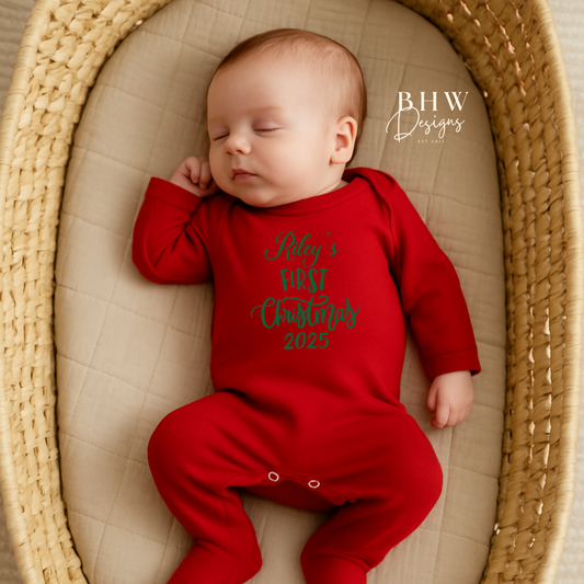Baby in a red onesie with text, Rileys First Christmas 2025 on the front in Green
