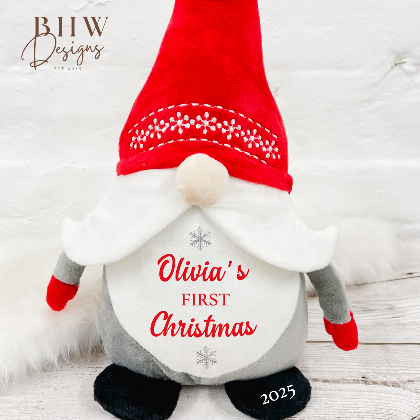 Christmas-themed gnome with red hat and white beard personalised with a name and first christmas in red with silver stars