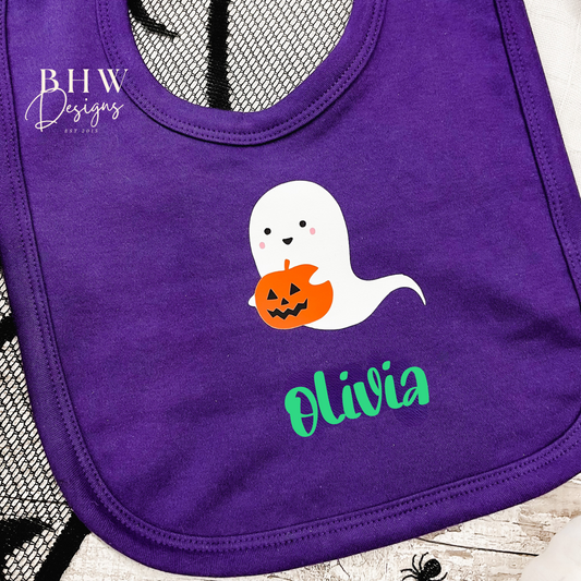 Purple bib with ghost holding a pumpkin and personalised with the name 'Olivia'