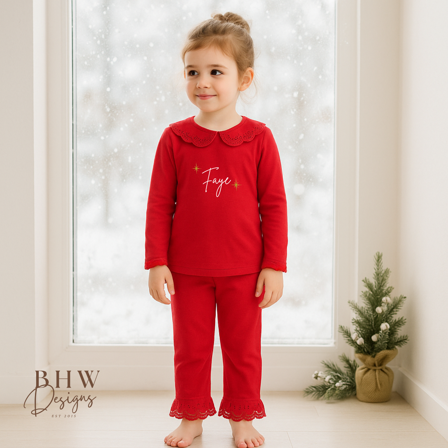 Child wearing red pyjamas with lace detail collar personalised n white with gold glitter stars