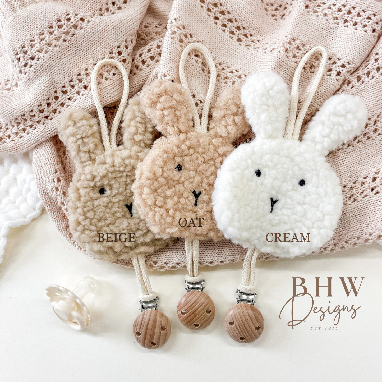 Three bunny-shaped dummy clips in beige, oat, and cream colours