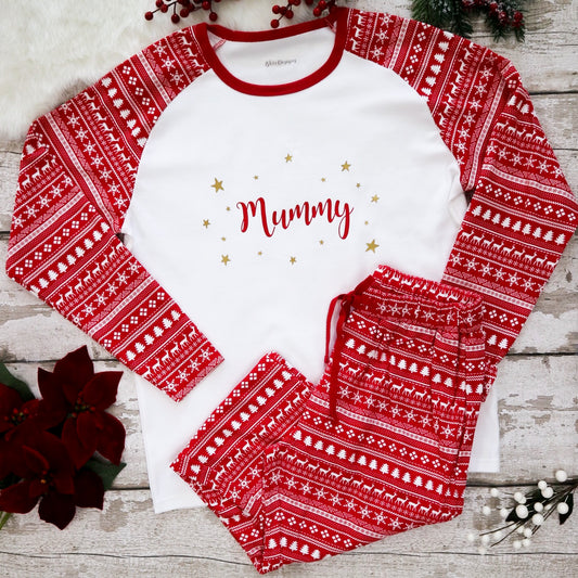 A pair of women's Christmas pyjamas with a red and white Fair Isle print, featuring the word 'Mummy' on the front and adorned with gold stars.