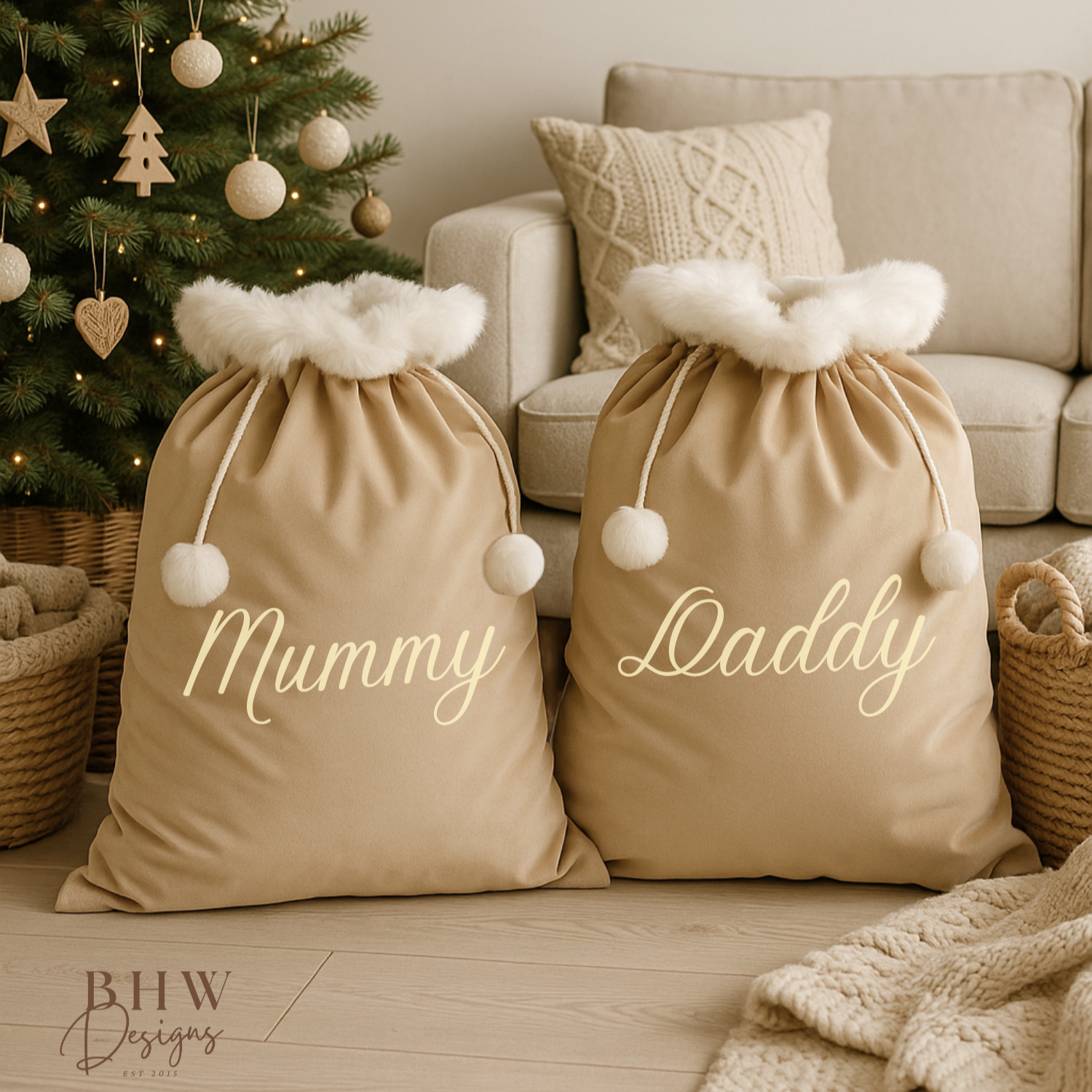Two beige personalised beige velvet Santa sack with 'Mummy' and 'Daddy' in a festive living room with a Christmas tree.