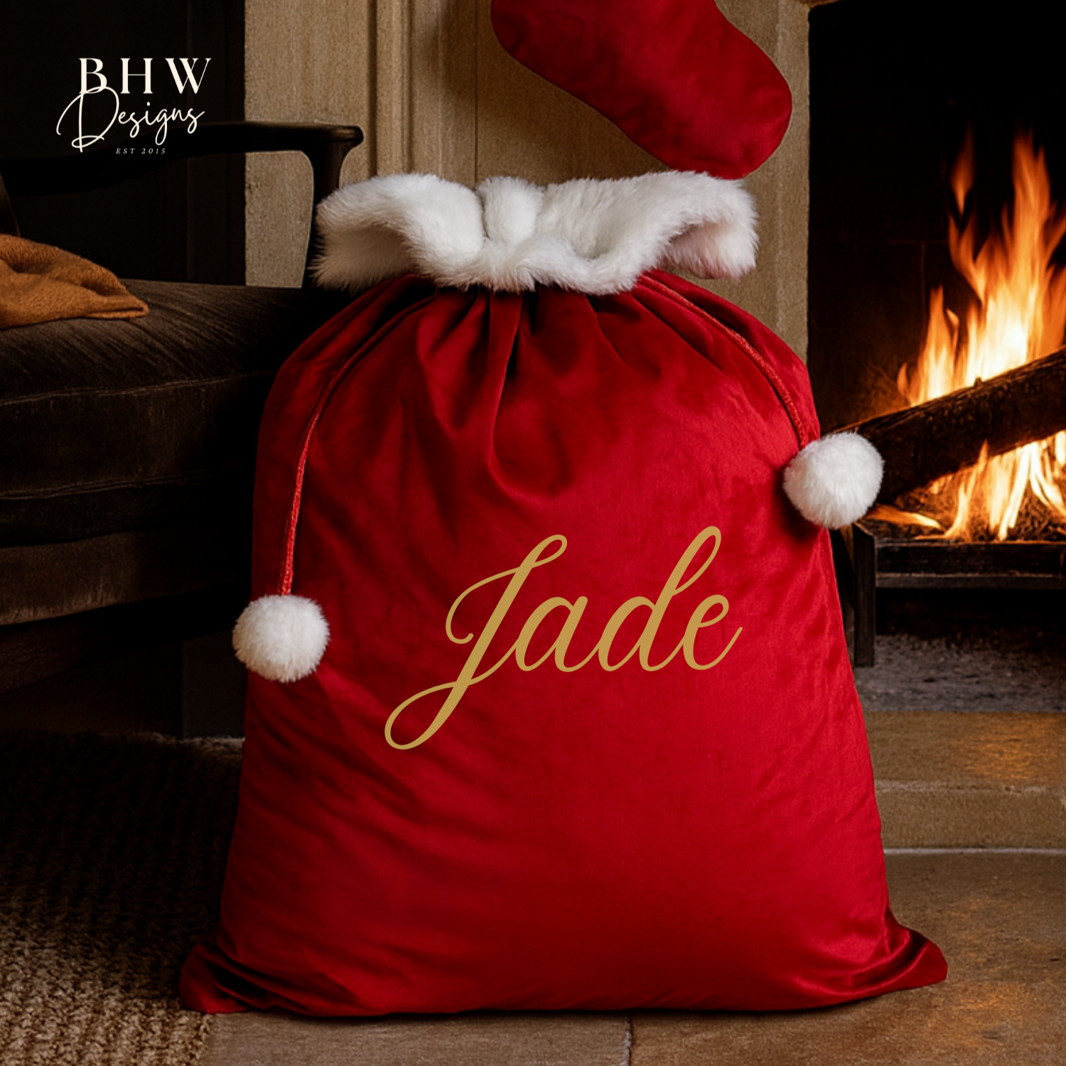 Red Christmas sack with 'Jade'  in gold, placed in front of a fireplace.