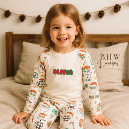 Child wearing Christmas-themed pyjamas with 'Olivia' printed on a bed, featuring 
