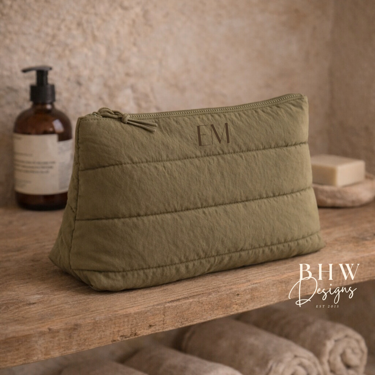 Olive green toiletry bag with 'EM on the front 