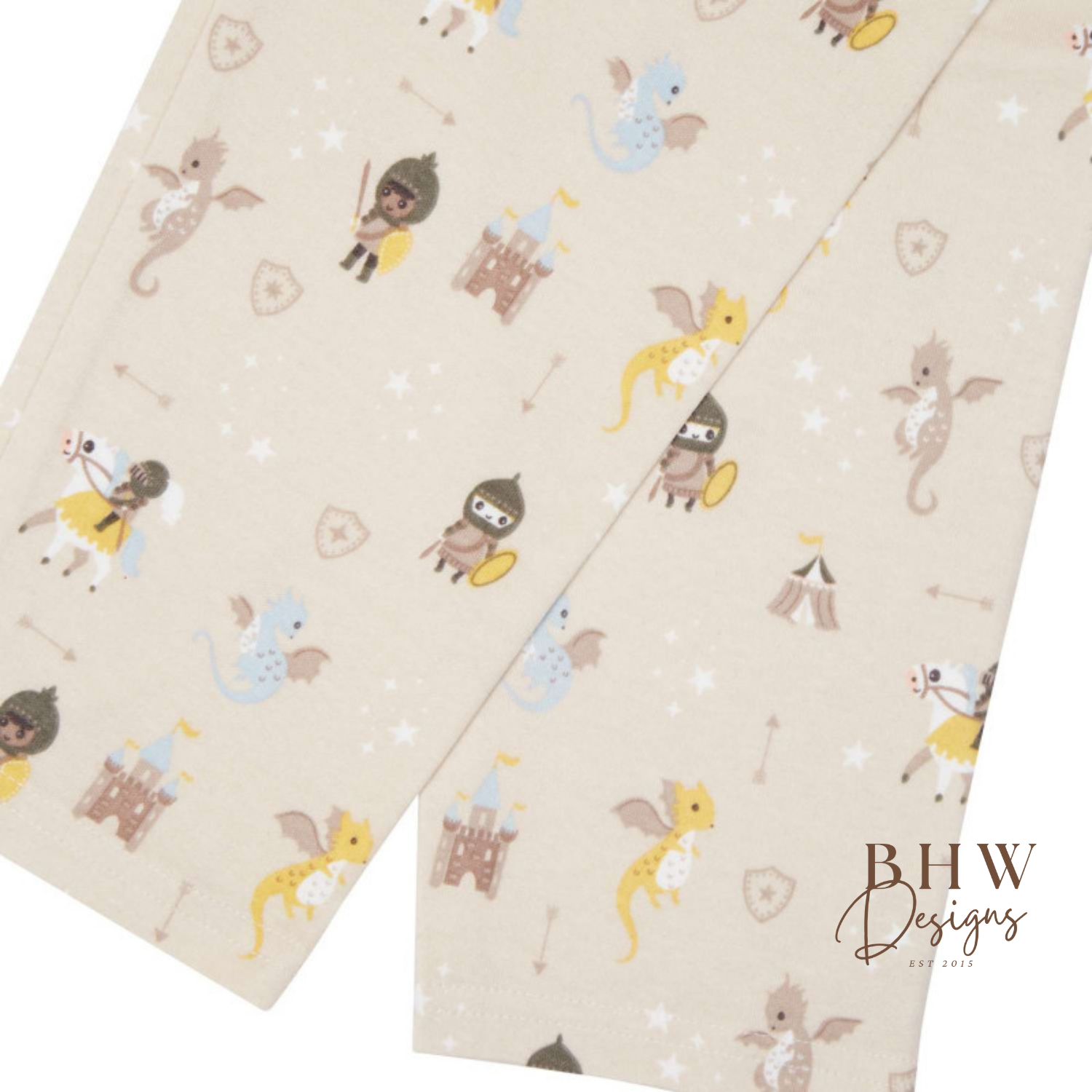 Fabric with a beige background and a dragon and knight and castle design 