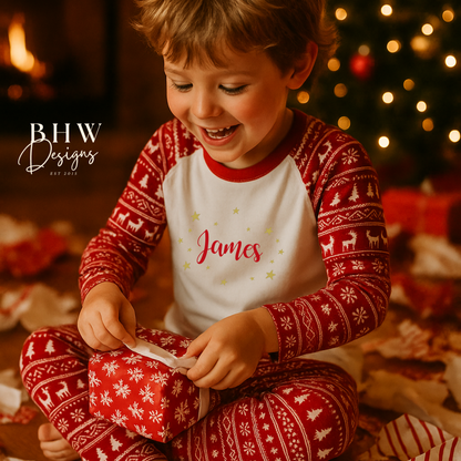 Boy in red and white fair isle print pyjamas opening a gift with Christmas decorations in the background