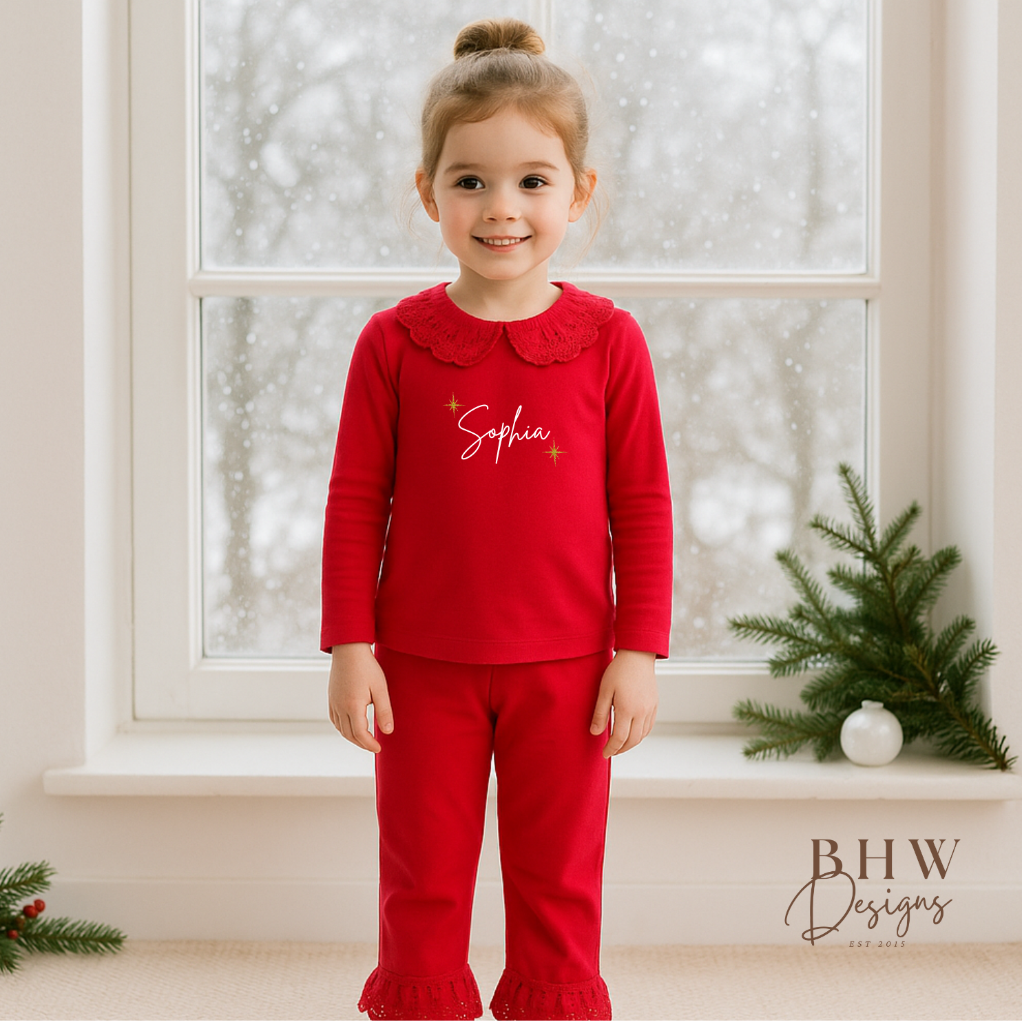 Child wearing red pyjamas with lace detail collar personalised n white with gold glitter stars 