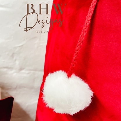 Red Santa hat with white pom-pom 