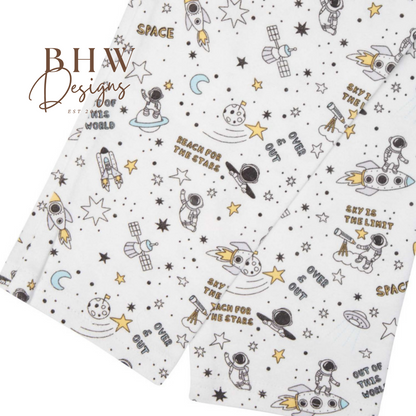 Fabric with space-themed designs and text on a white background, featuring logos and text.
