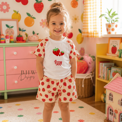 Child wearing a strawberry-themed outfit in a colorful room with toys and furniture.
