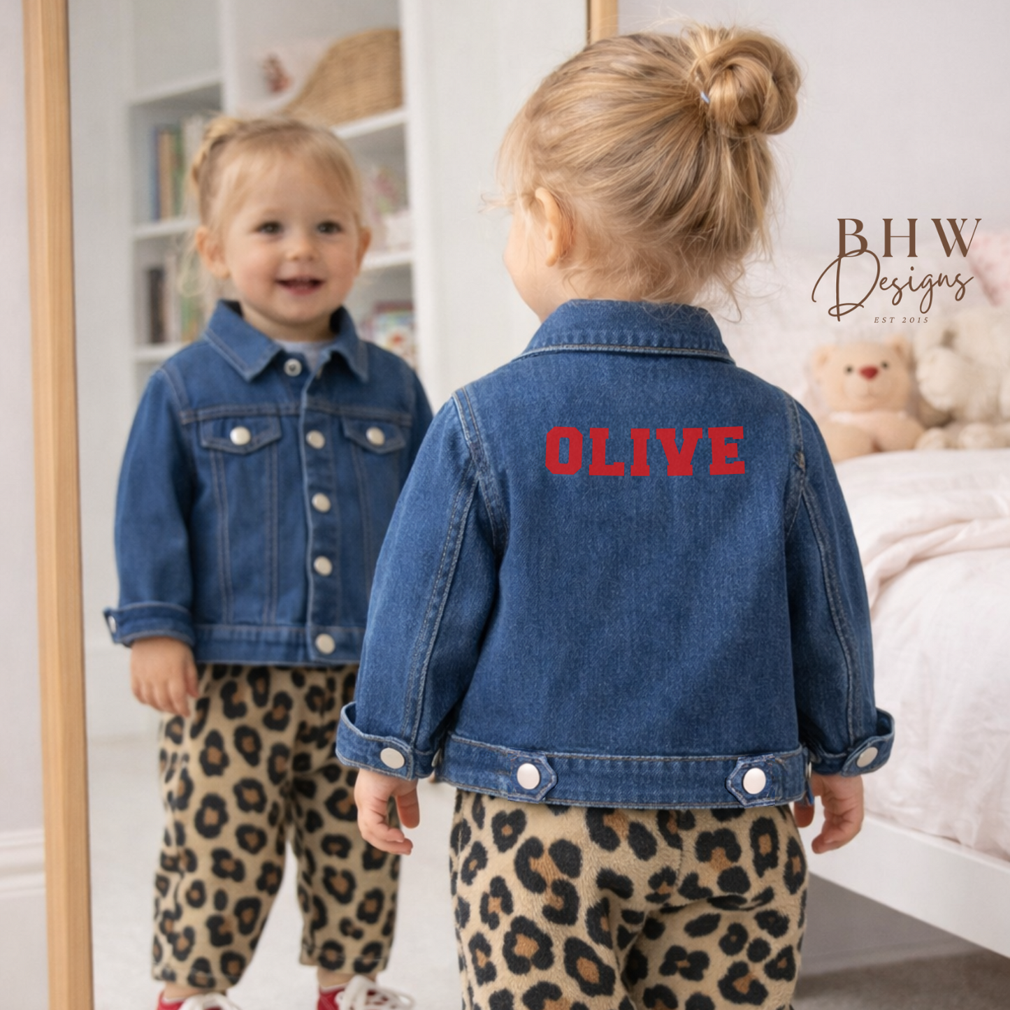 Child wearing a denim jacket with 'OLIVE' on the back in red