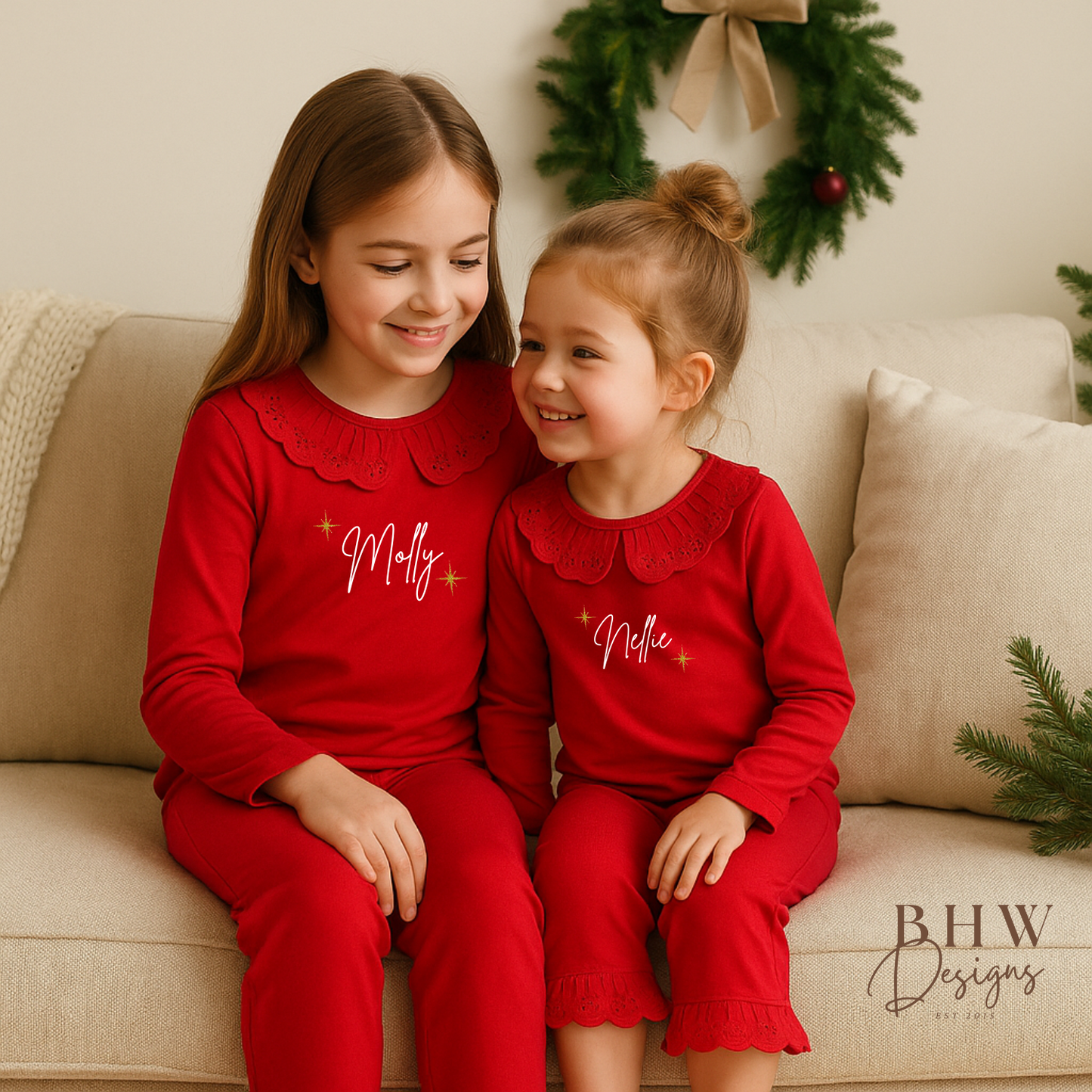 Two Children wearing red pyjamas with lace detail collar personalised n white with gold glitter stars 