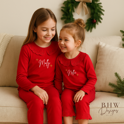 Two Children wearing red pyjamas with lace detail collar personalised n white with gold glitter stars 