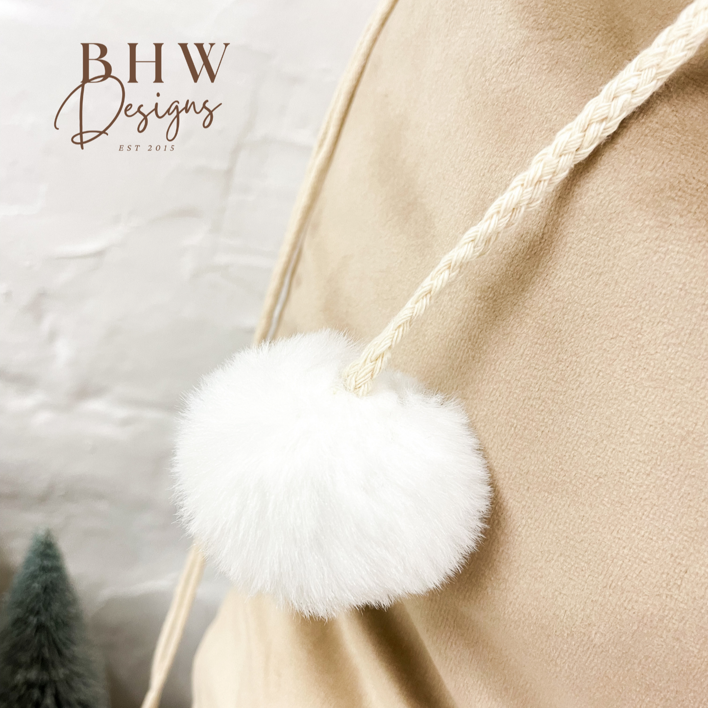 Close-up of a beige sack with a white fluffy pom-pom 