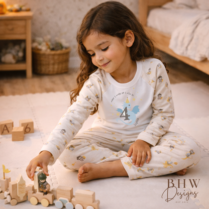 Child playing with wooden toys on a carpeted floor, wearing a pajama set with a number 4 design.