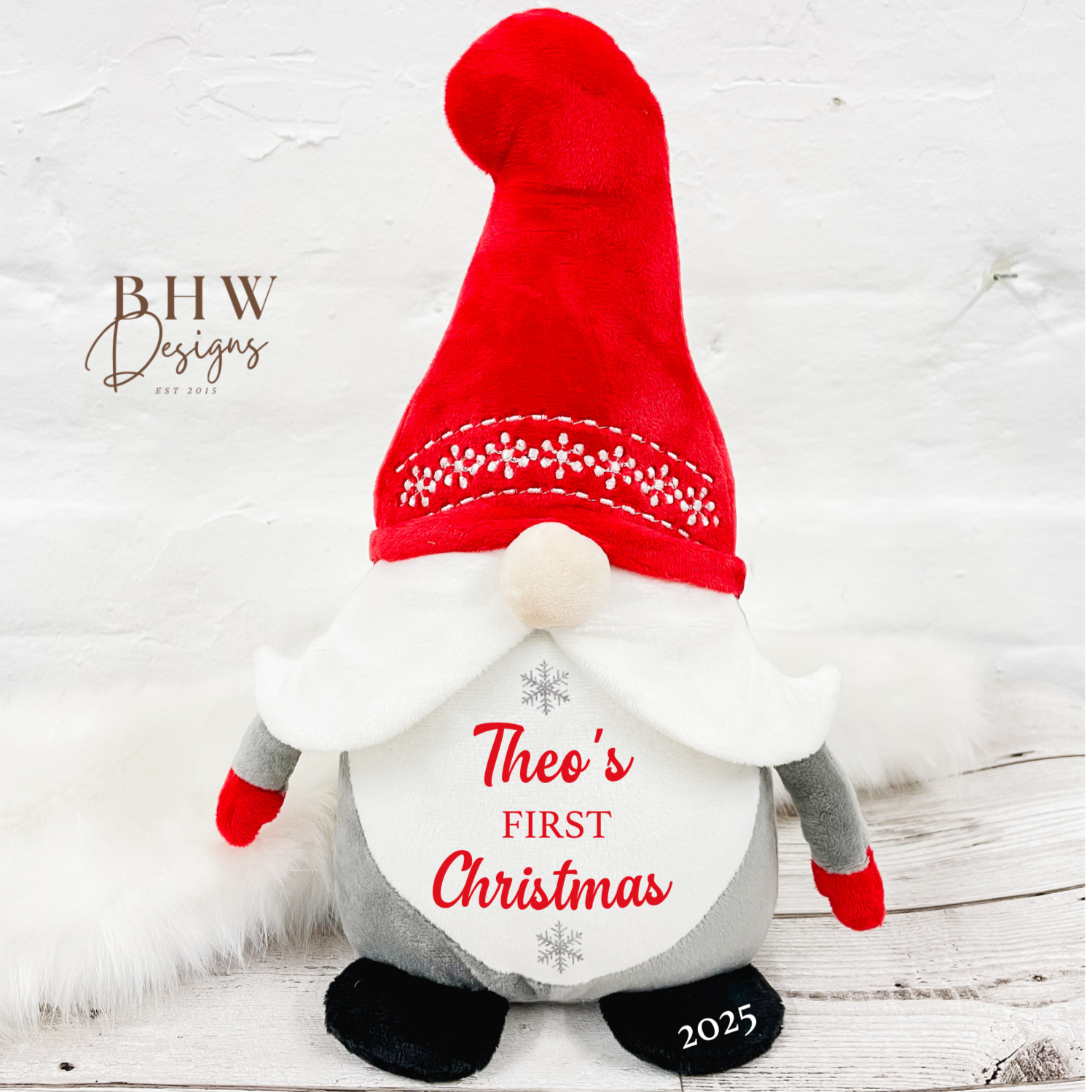 Christmas-themed gnome with red hat and white beard personalised with a name and first christmas in red with silver stars 