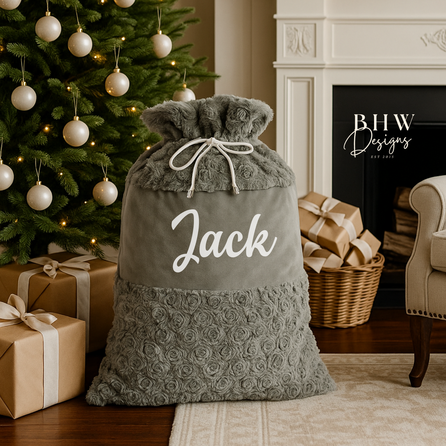 Grey Christmas sack with 'Jack' written on it, placed in front of a decorated Christmas tree and fireplace.