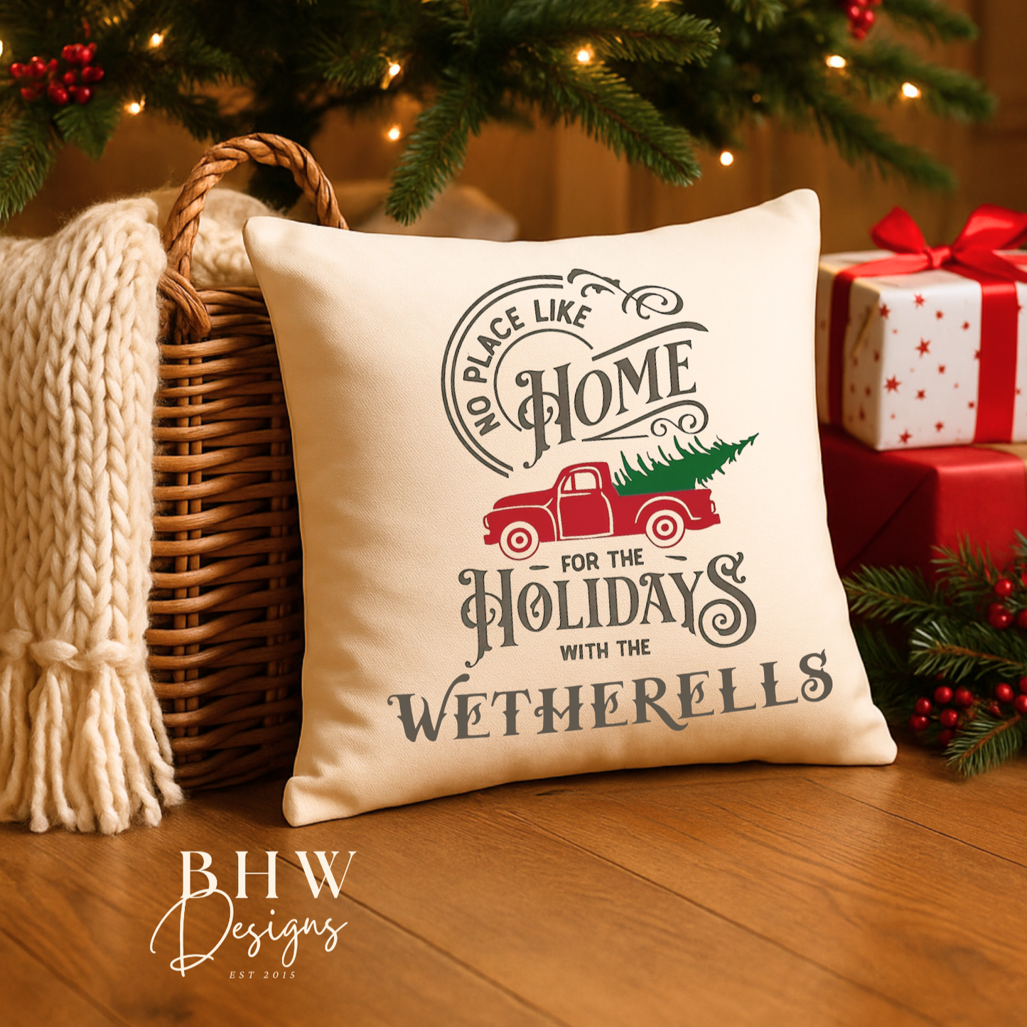 Decorative personalised family name no place like home Christmas cushion, placed under a decorated tree with presents.