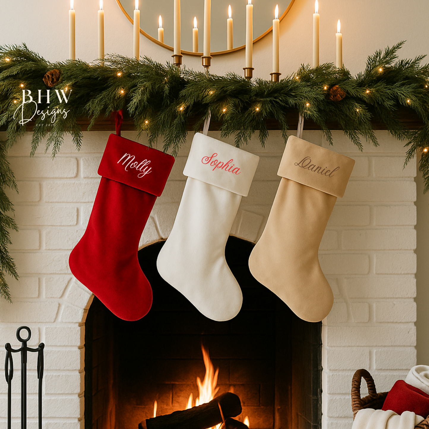 Three Christmas stockings hanging above a fireplace with decorative greenery and candles.