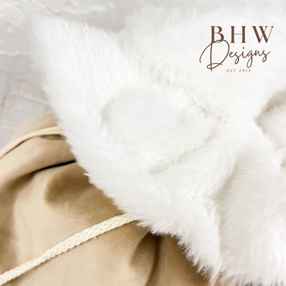 Close-up of a beige santa sack with white fur trim, 