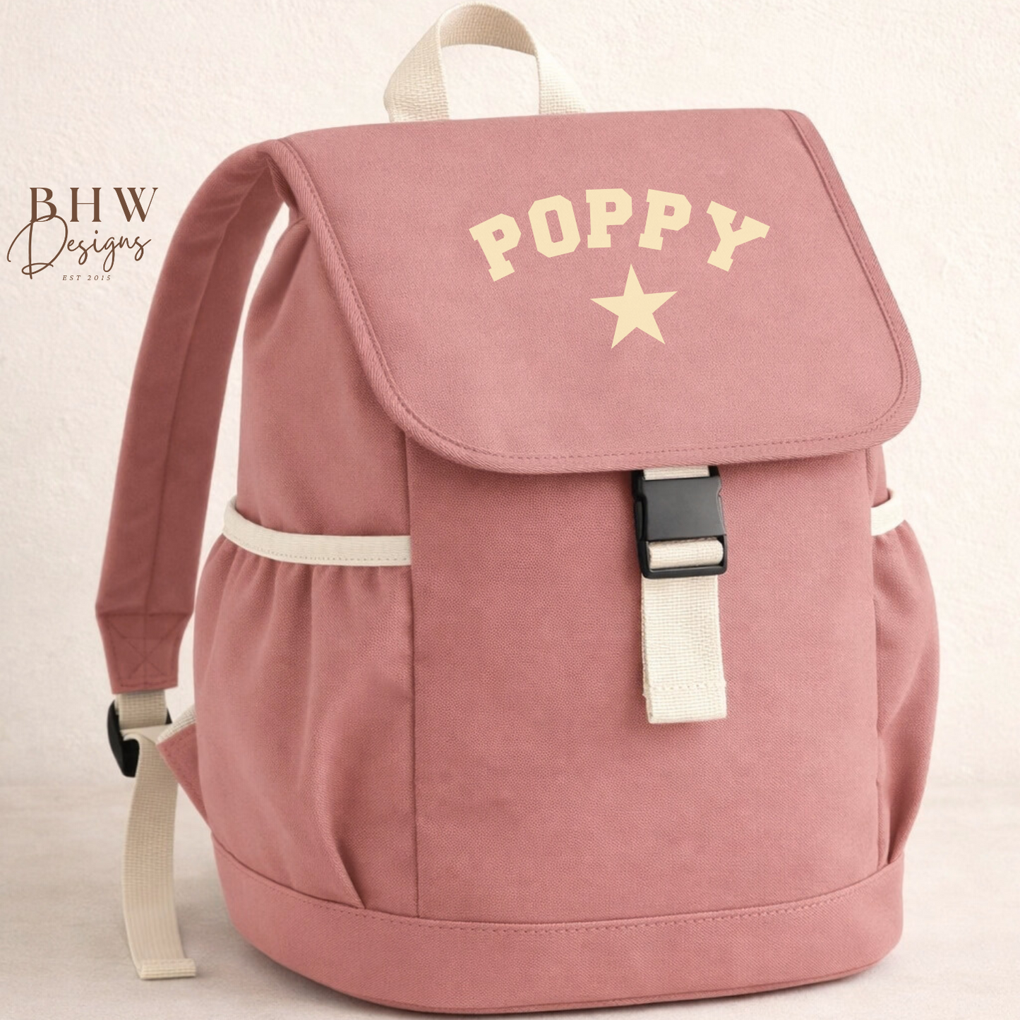 Pink backpack with 'Poppy' and a star on a light beige background
