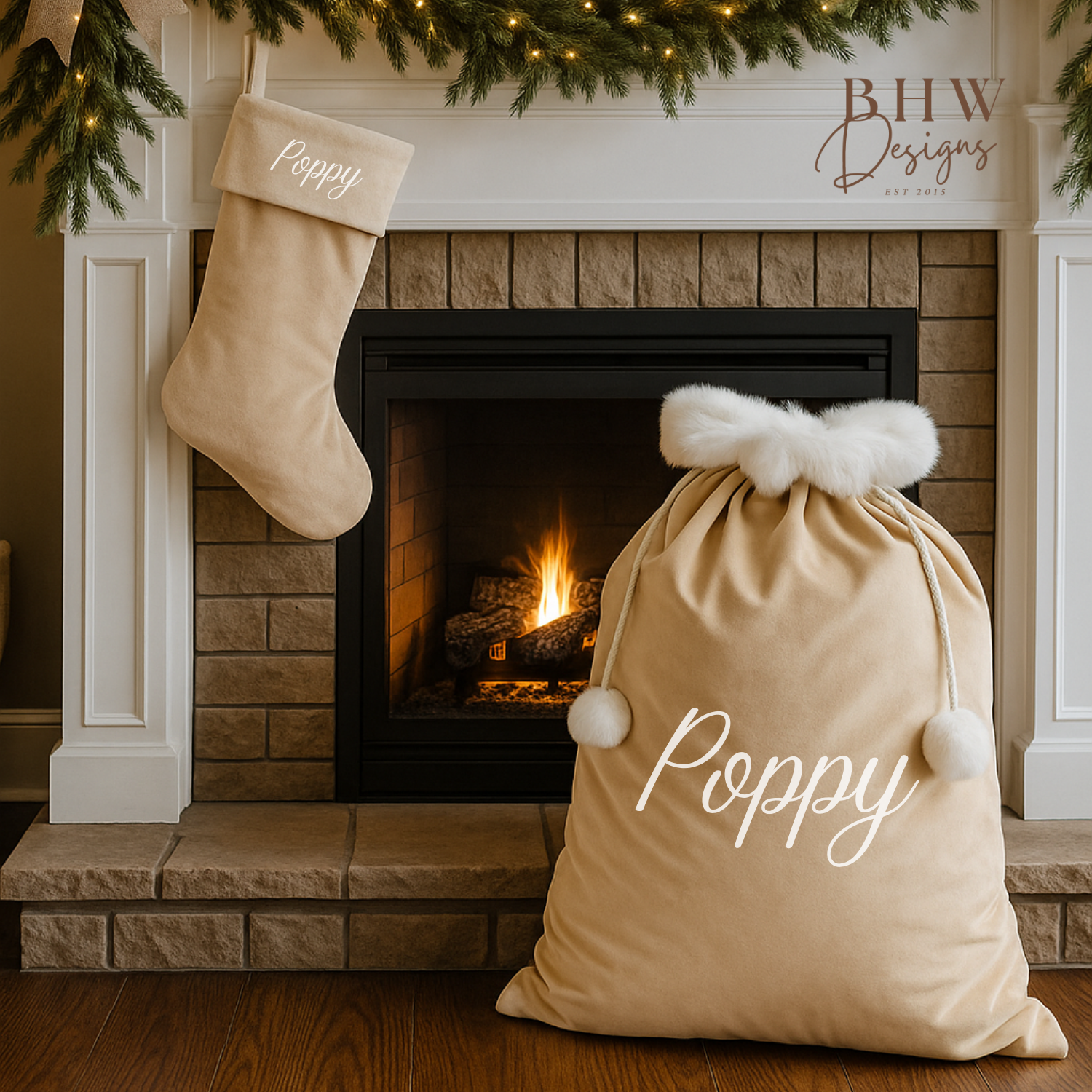 personalised beige velvet Santa sack with white pom-poms in front of a fireplace, featuring a Christmas stocking.