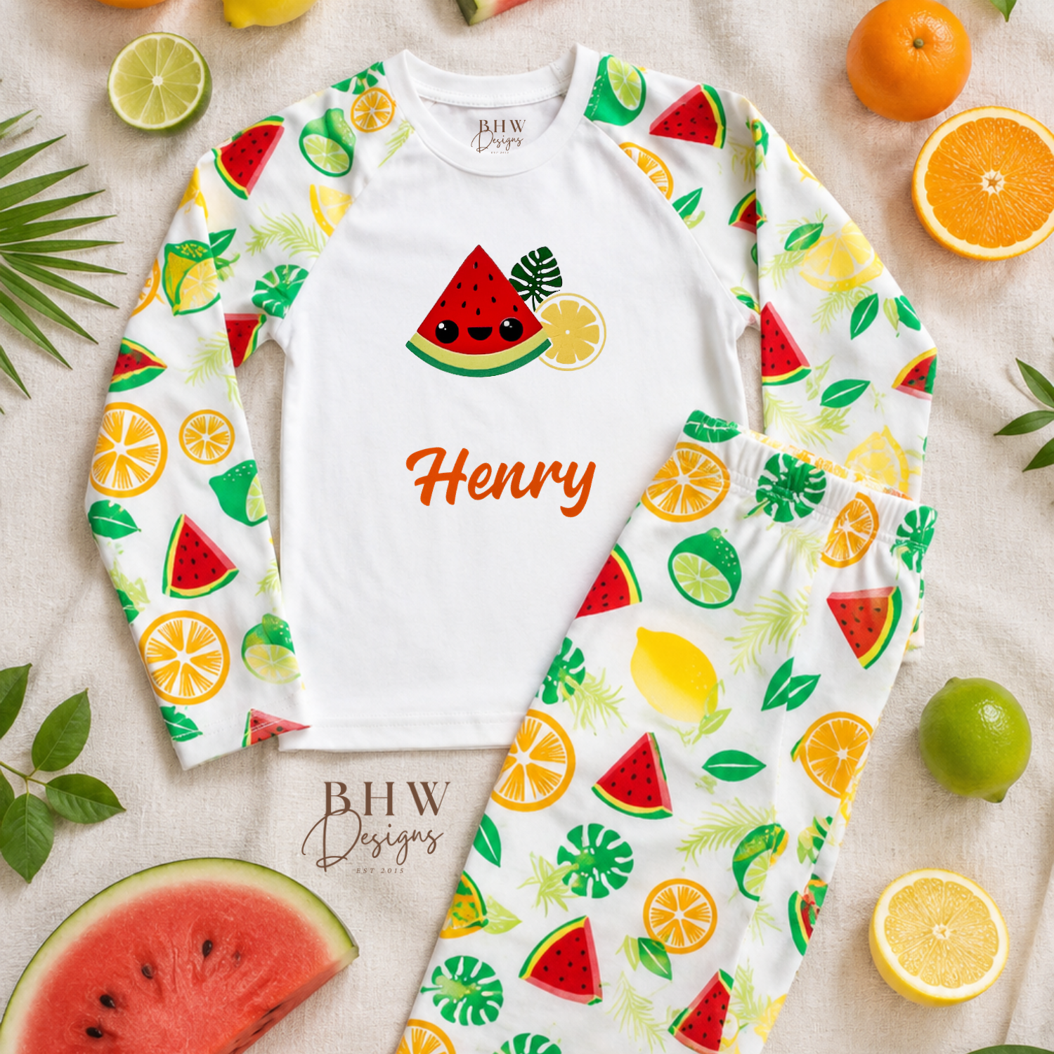 Fruit-themed children's pyjama set with 'Henry' printed on a white background, surrounded by fruits.