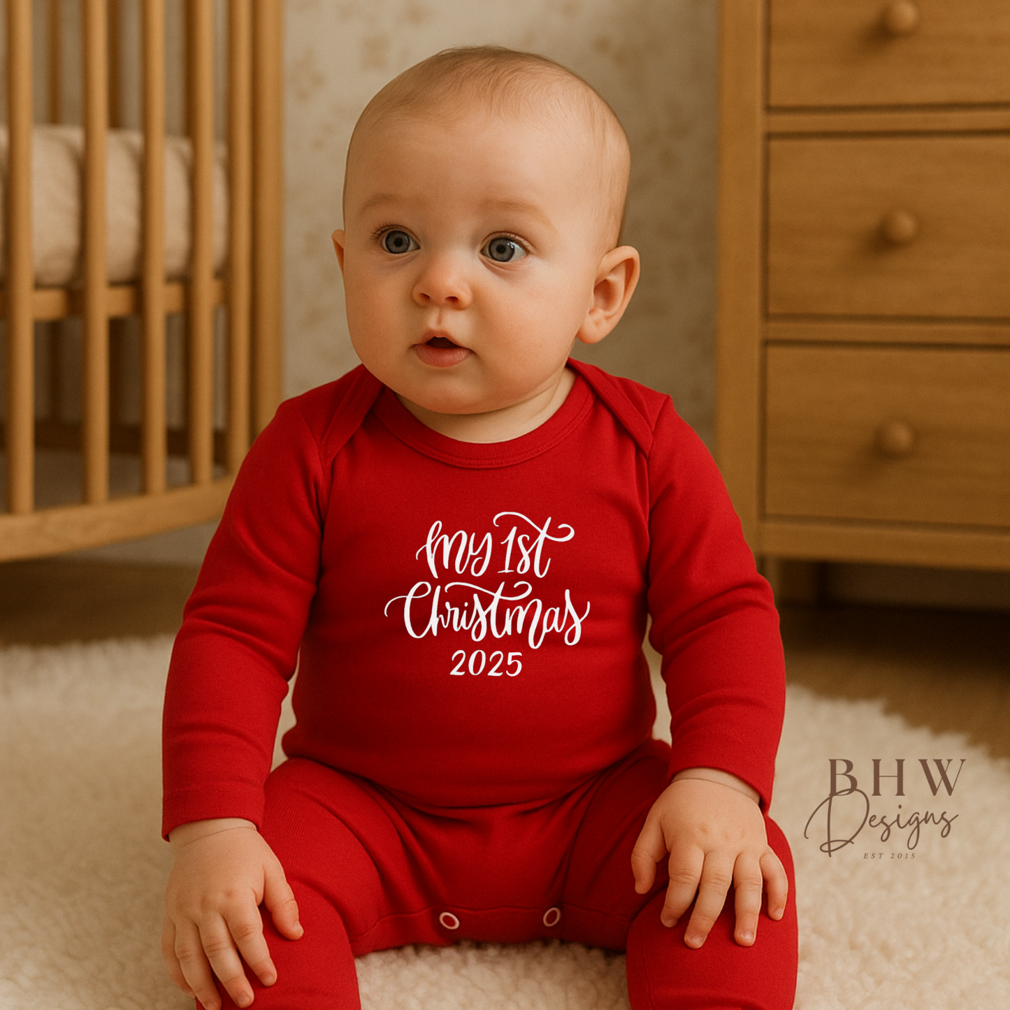 Baby in a red 'My 1st Christmas 2025' outfit sitting on the floor.