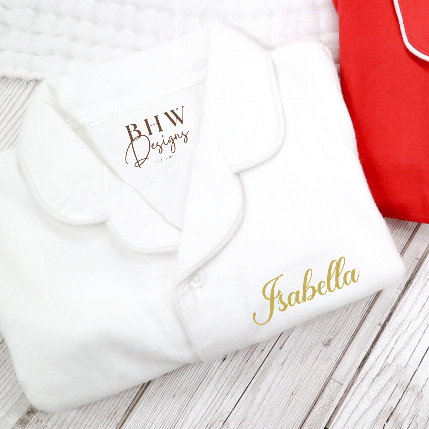 White pyjamas folded with Isabella printed in gold 