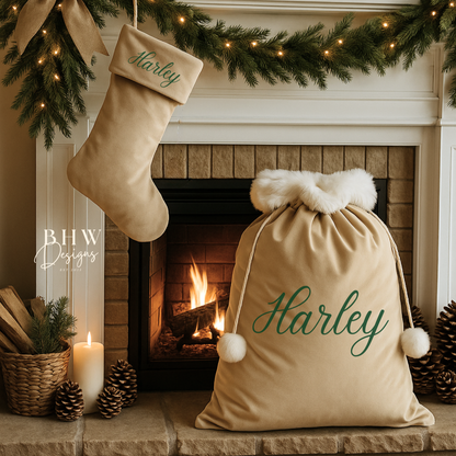 Decorative Christmas scene with stockings and a personalised beige velvet Santa sack in front of a fireplace.