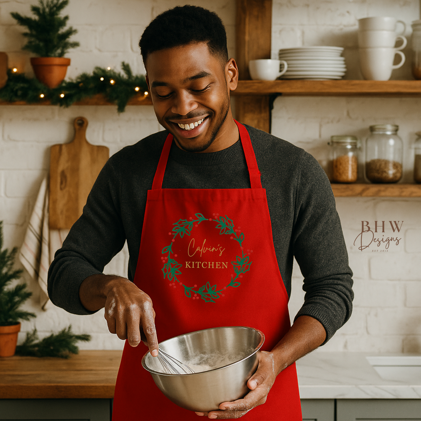 Man in a personalised red apron holding a mixing bowl in a kitchen.
