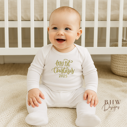 Baby wearing a 'My 1st Christmas 2025' onesie sitting in a crib.