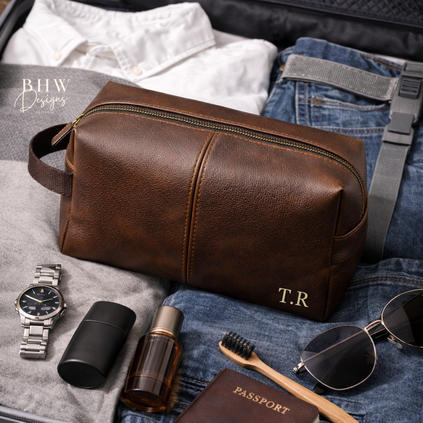 Brown faux leather wash bag with travel items on a suitcase