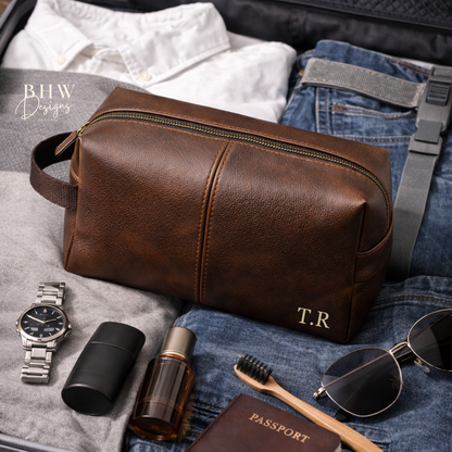 Brown faux leather wash bag with travel items on a suitcase
