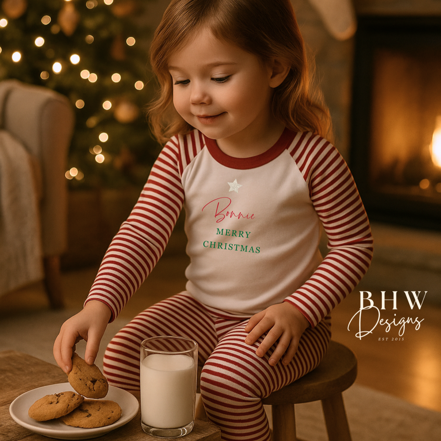 Child in red and white striped pyjamas with a silver glitter star, Bonnie in red and Merry Christmas in green. 
