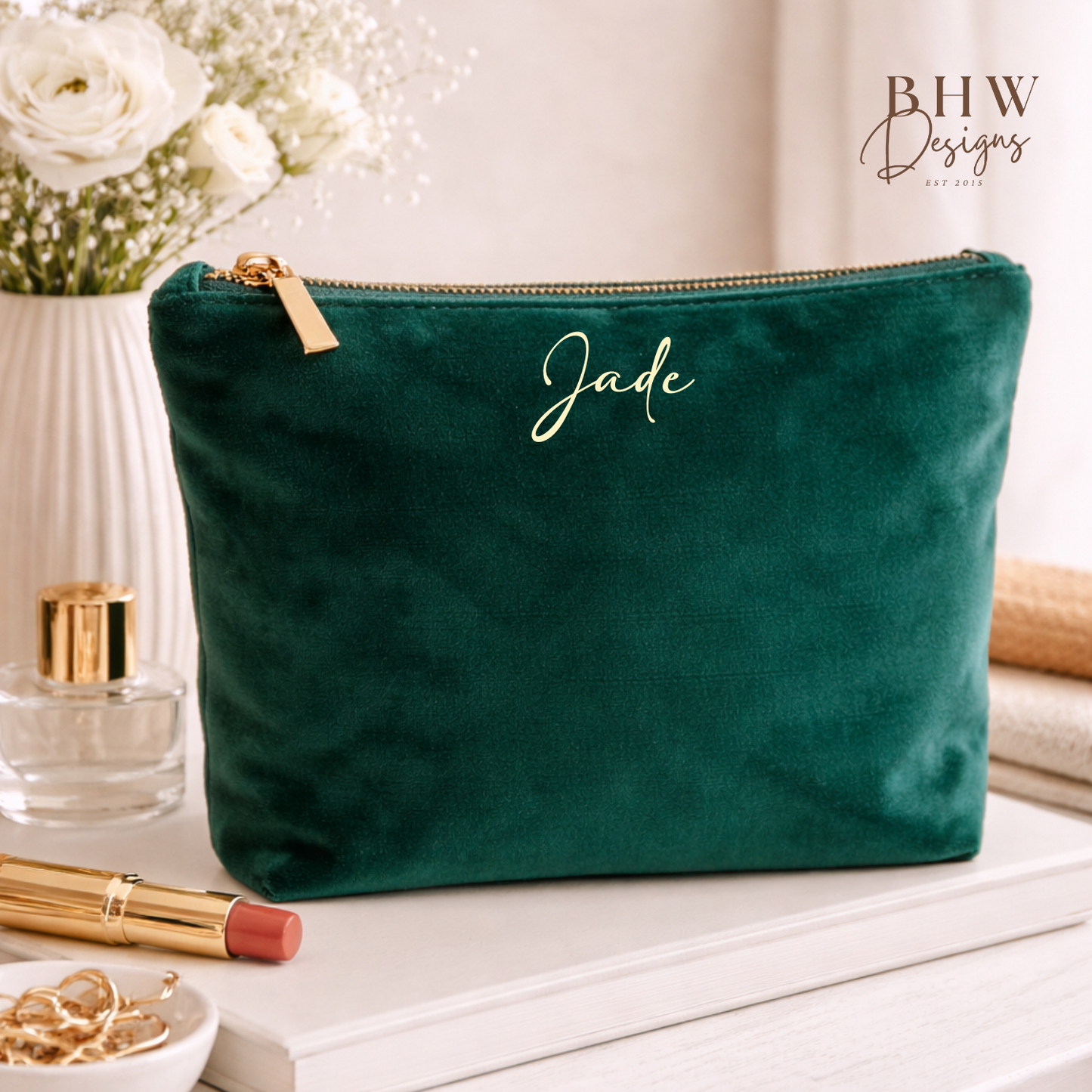 Green velvet pouch with 'Jade' branding on a table with beauty products.