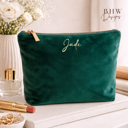 Green velvet pouch with 'Jade' branding on a table with beauty products.