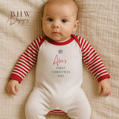 Baby wearing a red and white striped onesie with 'Alex's First Christmas 2025' 