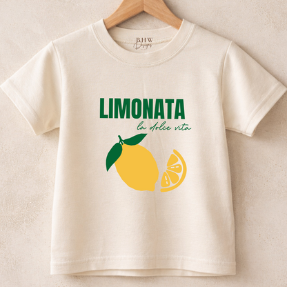 Children's t-shirt with lemon graphic and text on a hanger against a beige background